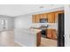 Modern kitchen with an island, stainless steel appliances, and wooden cabinets at 9617 Sharp Horn Ct, Las Vegas, NV 89149