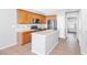 Well-lit kitchen featuring an island, tile flooring, stainless steel appliances, and wooden cabinets at 9617 Sharp Horn Ct, Las Vegas, NV 89149