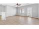 Bright living area featuring tile floors, a ceiling fan, and a staircase at 9617 Sharp Horn Ct, Las Vegas, NV 89149
