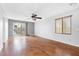 Large living room with wood floor, sliding door, ceiling fan and window at 9617 Sharp Horn Ct, Las Vegas, NV 89149
