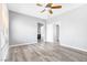 Open Primary bedroom with wood floors, natural light, and a view into the Primary bath at 9617 Sharp Horn Ct, Las Vegas, NV 89149