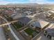 Expansive aerial view of a Primary-planned community featuring single Gathering homes with desert landscaping and mountain views at 10216 Chrysolite Pl, Las Vegas, NV 89143