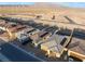 A high-angle view of a community showcasing modern homes with solar panels and desert landscaping at 10216 Chrysolite Pl, Las Vegas, NV 89143