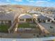An aerial view highlighting the backyard of a home with a manicured lawn and desert landscaping at 10216 Chrysolite Pl, Las Vegas, NV 89143
