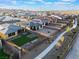 An aerial view of a neighborhood featuring homes with solar panels and well-maintained lawns and landscaping at 10216 Chrysolite Pl, Las Vegas, NV 89143