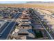 Aerial view of a neighborhood highlighting modern homes with pools and solar panels in a desert setting at 10216 Chrysolite Pl, Las Vegas, NV 89143