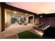 Covered back patio with lounge seating and decorative planters in the backyard garden at 10216 Chrysolite Pl, Las Vegas, NV 89143