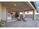 Covered patio with sliding glass doors into open concept living space and outdoor furniture at 10216 Chrysolite Pl, Las Vegas, NV 89143