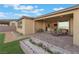 View of landscaped patio and manicured backyard with outdoor seating and desert plants at 10216 Chrysolite Pl, Las Vegas, NV 89143