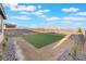Spacious backyard area with artificial turf, desert landscaping and mountain views, perfect for outdoor living at 10216 Chrysolite Pl, Las Vegas, NV 89143