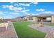 Spacious backyard features lush artificial grass, mature landscaping, and a peaceful outdoor retreat at 10216 Chrysolite Pl, Las Vegas, NV 89143