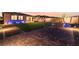 Evening view of the backyard, showcasing the brick paver patio and artificial grass at 10216 Chrysolite Pl, Las Vegas, NV 89143