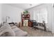Comfortable bedroom features neutral carpet, large window, and space for an office or lounging area at 10216 Chrysolite Pl, Las Vegas, NV 89143