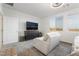 Bright bedroom featuring a sitting area and two large windows with views at 10216 Chrysolite Pl, Las Vegas, NV 89143