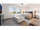 Serene bedroom with natural light, a cozy seating area, and mountain views at 10216 Chrysolite Pl, Las Vegas, NV 89143