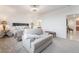 Spacious primary bedroom with carpeting and featuring a comfortable seating area at 10216 Chrysolite Pl, Las Vegas, NV 89143