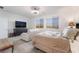 This bedroom features a comfortable bed, a sofa, and a dresser with a TV at 10216 Chrysolite Pl, Las Vegas, NV 89143
