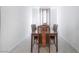 This dining room features a minimalist design and a wooden table and chairs at 10216 Chrysolite Pl, Las Vegas, NV 89143