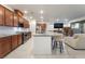 Open-concept kitchen with stainless steel appliances and a large kitchen island at 10216 Chrysolite Pl, Las Vegas, NV 89143