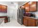 Kitchen with stainless steel refrigerator, ample cabinet space, and granite countertops at 10216 Chrysolite Pl, Las Vegas, NV 89143