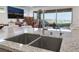 Modern kitchen with granite counters, stainless steel faucet and a large sink at 10216 Chrysolite Pl, Las Vegas, NV 89143