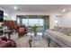 Bright living room with large sliding glass doors and comfortable seating at 10216 Chrysolite Pl, Las Vegas, NV 89143