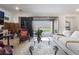 Bright living room with large sliding glass doors and comfortable seating at 10216 Chrysolite Pl, Las Vegas, NV 89143