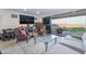 Bright living room with patio access, stylish furniture, and modern entertainment setup at 10216 Chrysolite Pl, Las Vegas, NV 89143