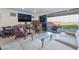 Comfortable living room with fireplace, entertainment center, and a sliding glass door to the patio at 10216 Chrysolite Pl, Las Vegas, NV 89143