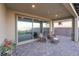 Picturesque covered patio boasts comfortable seating and scenic views of the landscaped backyard at 10216 Chrysolite Pl, Las Vegas, NV 89143