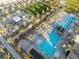 Aerial view of community pool featuring lap lanes, lounge areas, and inviting cabanas amidst lush palm trees at 10216 Chrysolite Pl, Las Vegas, NV 89143
