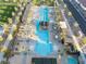 Aerial view of the sparkling community pool featuring palm trees and stylish lounging areas at 10216 Chrysolite Pl, Las Vegas, NV 89143