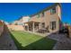 Artificial grass, BBQ, covered patio, and privacy wall in the backyard at 10415 Andele Ave, Las Vegas, NV 89166