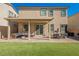 Manicured backyard featuring a covered patio, outdoor seating, and artificial turf at 10415 Andele Ave, Las Vegas, NV 89166