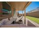 Backyard featuring a covered patio with outdoor seating and artificial turf at 10415 Andele Ave, Las Vegas, NV 89166