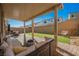 Inviting covered patio, outdoor seating and a lawn of artificial grass at 10415 Andele Ave, Las Vegas, NV 89166