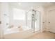 Bright bathroom with a tub and shower combination at 10415 Andele Ave, Las Vegas, NV 89166