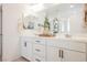 Bathroom with double sinks, white cabinets, and walk-in shower at 10415 Andele Ave, Las Vegas, NV 89166