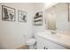 Bathroom showcasing a vanity with decorative shelves, wall decor and toilet at 10415 Andele Ave, Las Vegas, NV 89166