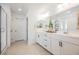 Bathroom with double sinks, white cabinets, and walk-in shower at 10415 Andele Ave, Las Vegas, NV 89166