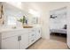 Bathroom featuring double sinks, and an open view into the bedroom at 10415 Andele Ave, Las Vegas, NV 89166