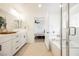 Bathroom featuring double sinks, a bathtub, and an open view into the bedroom at 10415 Andele Ave, Las Vegas, NV 89166