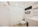 Bathroom with a white shower curtain and ceramic tile flooring at 10415 Andele Ave, Las Vegas, NV 89166