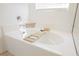 Close up of a pristine white bathtub with wooden tray at 10415 Andele Ave, Las Vegas, NV 89166
