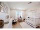 Bedroom with a white crib, wooden floors, and a changing table at 10415 Andele Ave, Las Vegas, NV 89166
