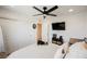 Bedroom with a ceiling fan, a wall-mounted television and wood flooring at 10415 Andele Ave, Las Vegas, NV 89166
