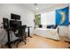 Bright bedroom featuring a desk with a multi-monitor setup and daybed near a window at 10415 Andele Ave, Las Vegas, NV 89166