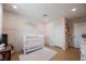 Bedroom features a white crib with a soft rug and bright paint at 10415 Andele Ave, Las Vegas, NV 89166