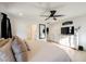 Bedroom featuring a king-size bed, ceiling fan, dresser with television, and stylish accents at 10415 Andele Ave, Las Vegas, NV 89166