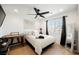 Bright bedroom features a ceiling fan, a writing desk and light wood flooring at 10415 Andele Ave, Las Vegas, NV 89166